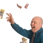 ASX dividend share investor throwing $50 notes in the air and laughing
