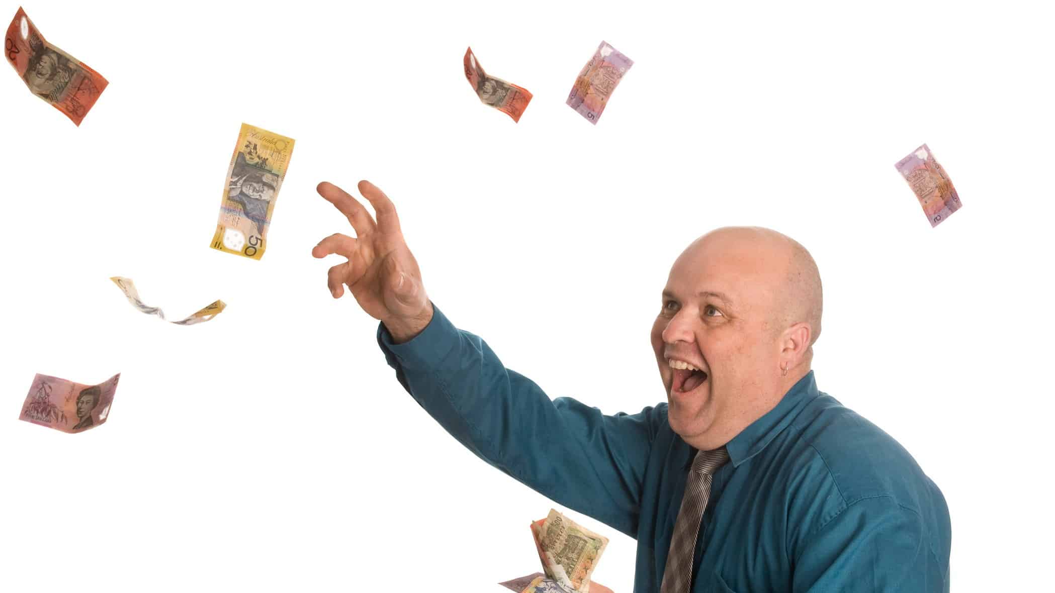 ASX dividend share investor throwing $50 notes in the air and laughing