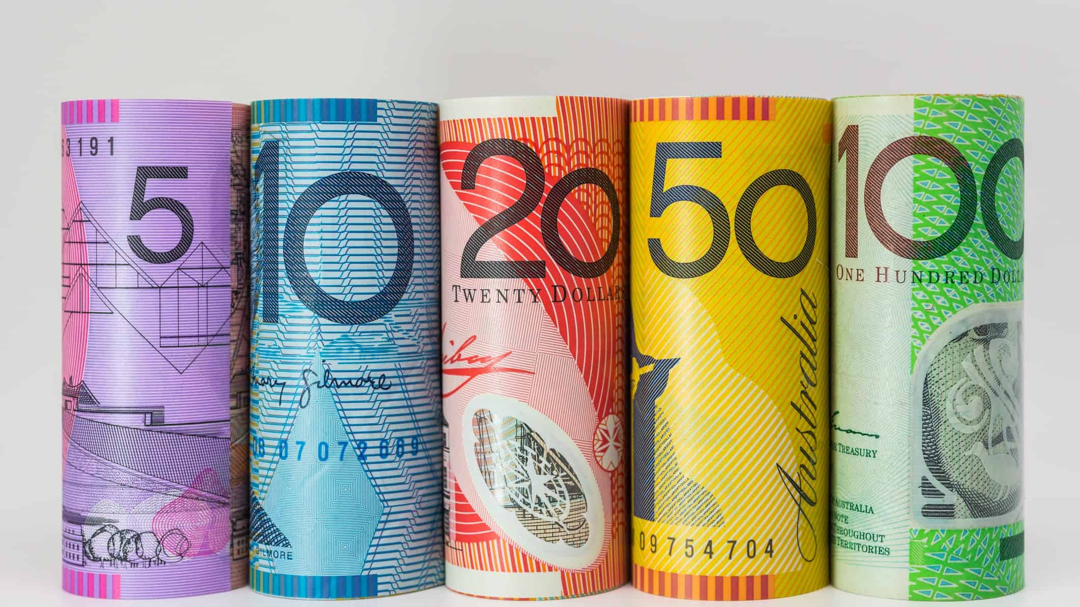 Australian dollar notes rolled into bundles.