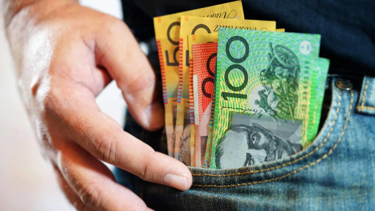 Australian dollar notes inside the pocket on jeans, symbolising dividends.