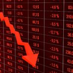 Red arrow going down on a stock market chart, with share prices in red.