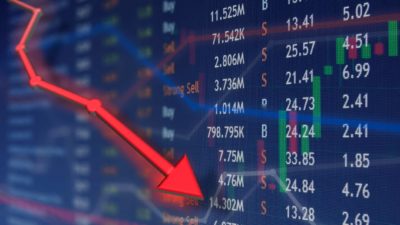 Red arrow going down on a stock market table which symbolises a falling share price.