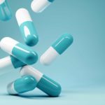 Falling pills in a blue background.