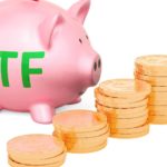 ETF written in green on a piggy bank with increasing pile of coins.