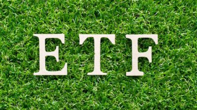 ETF written in white on a grass background.