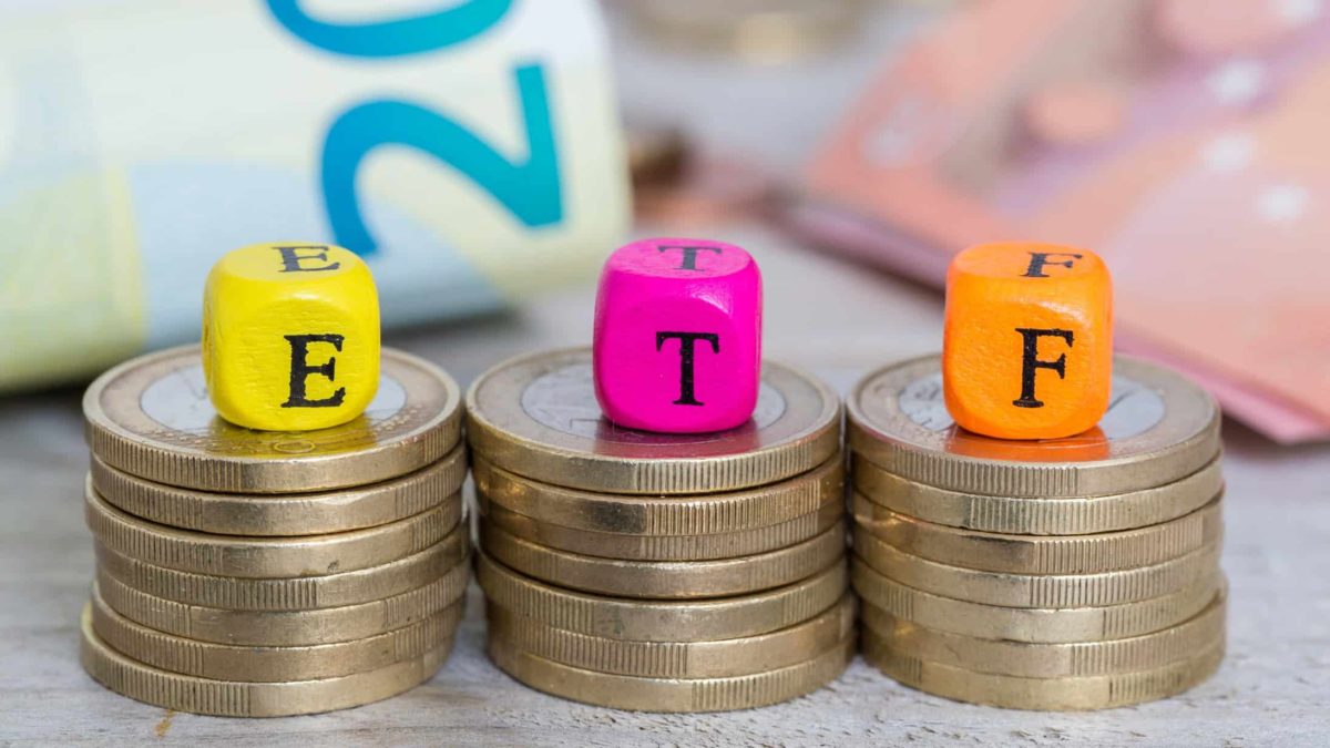 ETF written on cubes sitting on piles of coins.