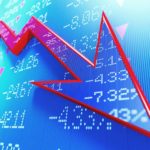 Rede arrow on a stock market chart going down.