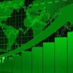 Rising green bar graph with an arrow and a world map, symbolising a rising share price.