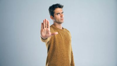 Man with his hand out, symbolising a trading halt.