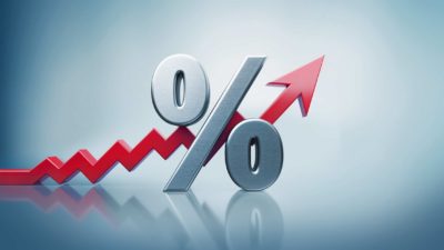 Percentage sign with a rising zig zaggy arrow representing rising interest rates.