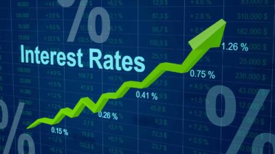 Interest rate written with a green arrow going up, symbolising rising interest rates.