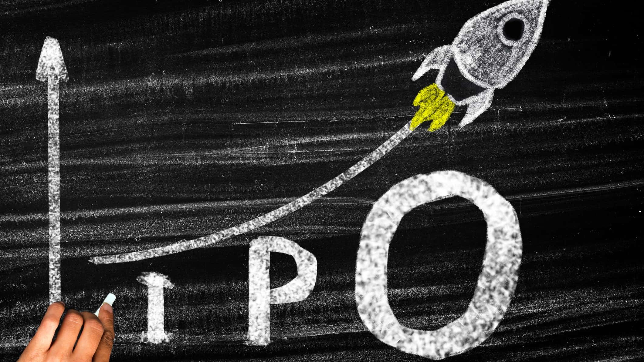 IPO written on a chalk board with a rising rocket.
