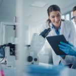 Two researchers discussing results of a study with each other.