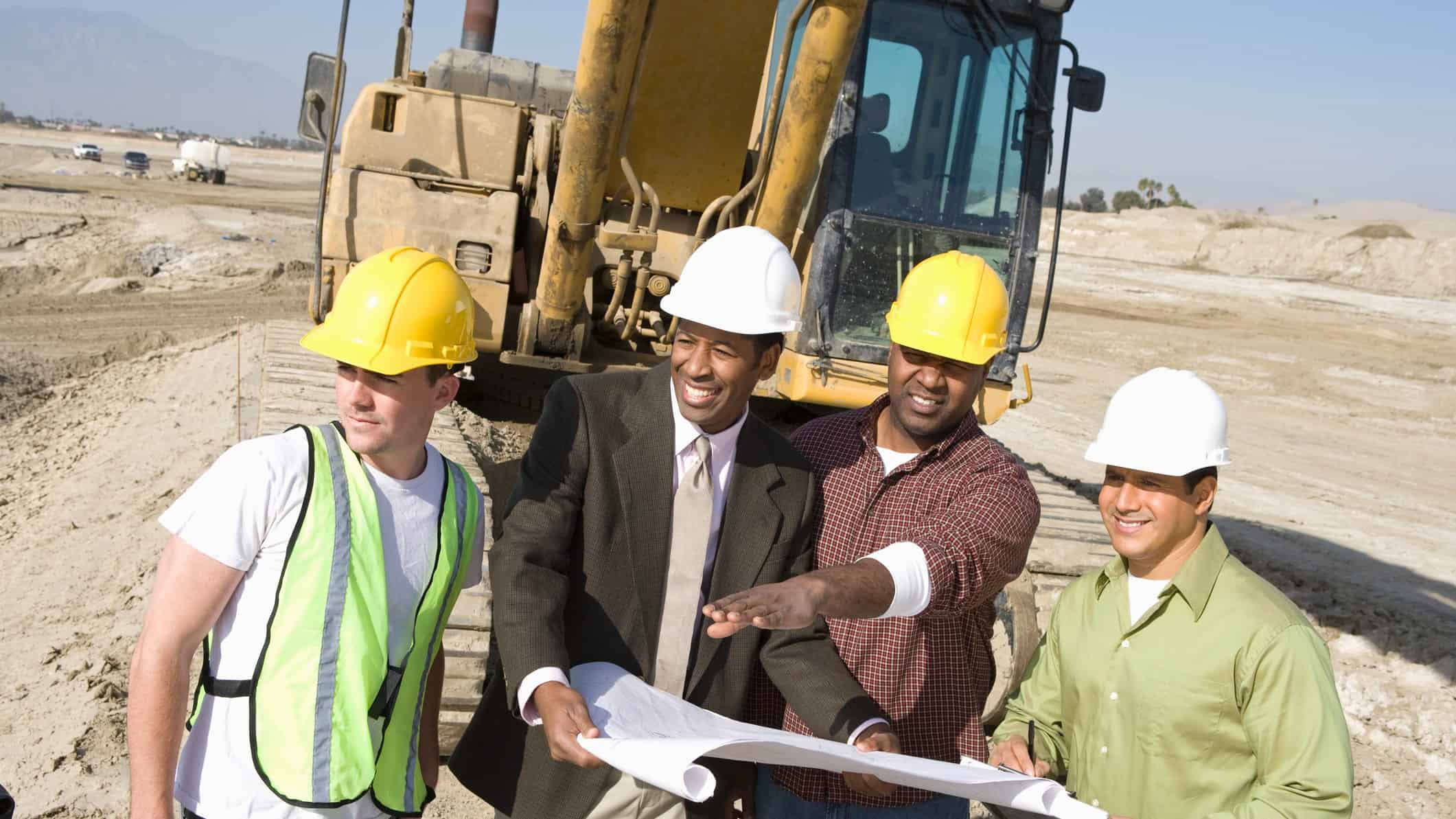 Inspectors and workers discussing with each other at a mine site.