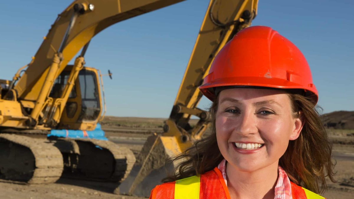 Female miner smiling at a mine site.
