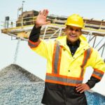 Happy miner with his hand in the air.