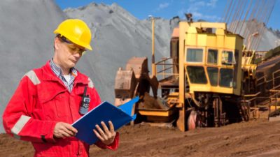 Miner looking at his notes.