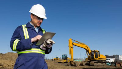 Miner looking at a tablet.