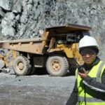 Female miner on a walkie talkie.