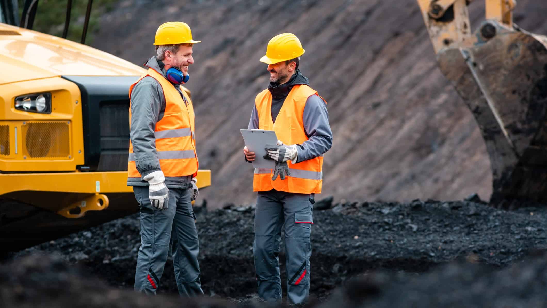 Two miners talking to each other.