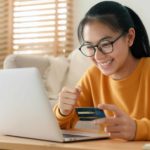 Happy woman shopping online.