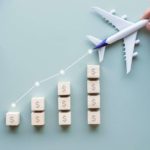 Rising plane share price represented by a inclining line with a model plane at the end.