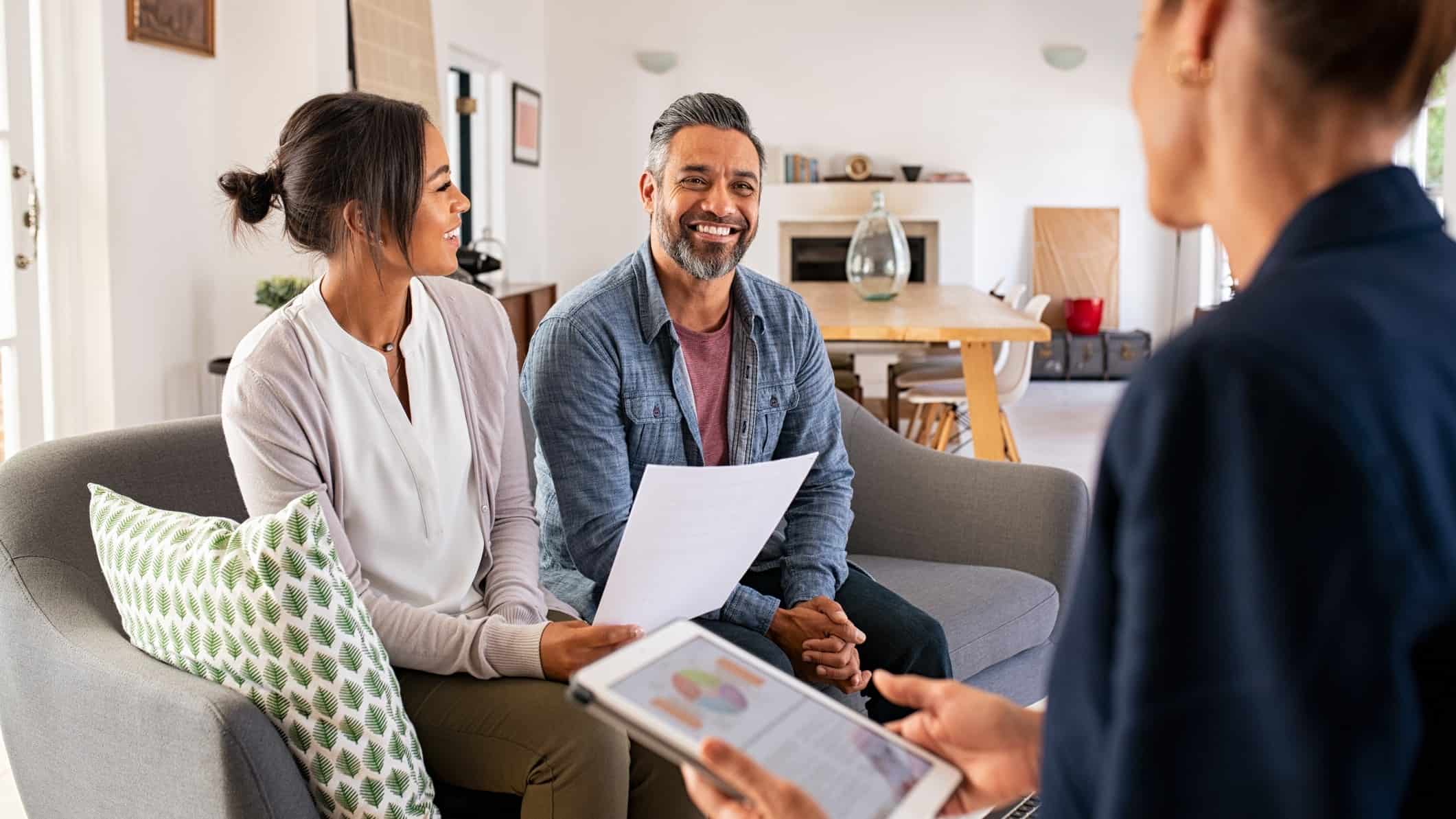 couple talking with a real estate agent.