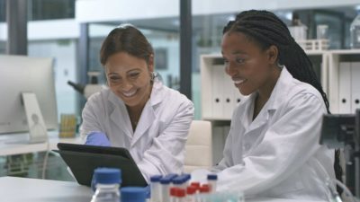 Two happy scientists analysing test results.