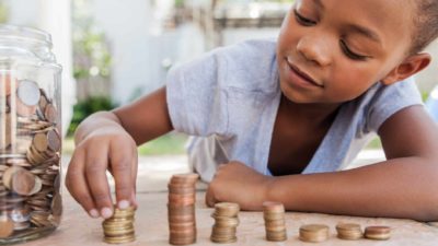 Kid stacking coins from the jar.