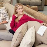 Two happy woman on a sofa.
