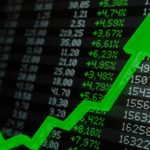 Green arrow going up on a stock market chart, symbolising a rising share price.