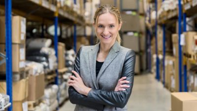Woman smiling in a warehouse.