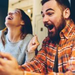 A couple are shocked and elated at the good news they've just seen on their devices.
