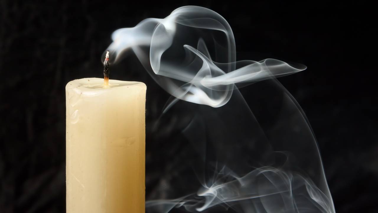 A white candle with a smoking wick symbolising the fall in the Dusk share price today