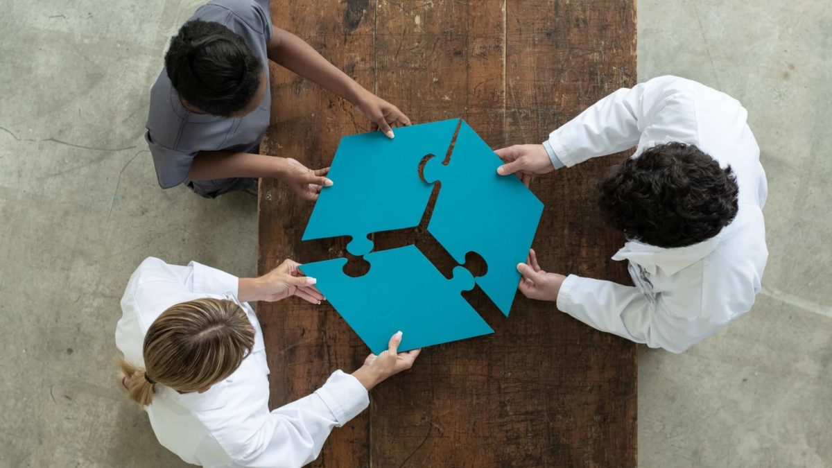 Three people connect their puzzle pieces together to make a triple threat.