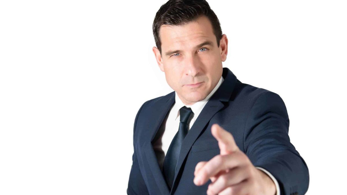 A businessman wearing a dark suit points at the camera in a gesture to represent Soul Patts encouraging AGL to give more thought to the Brookfield Consortium's takeover bid