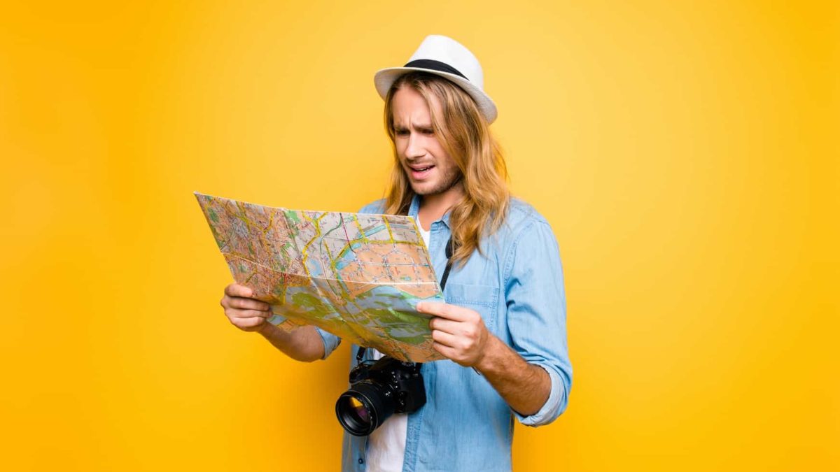 A man looks at a map, totally confused.