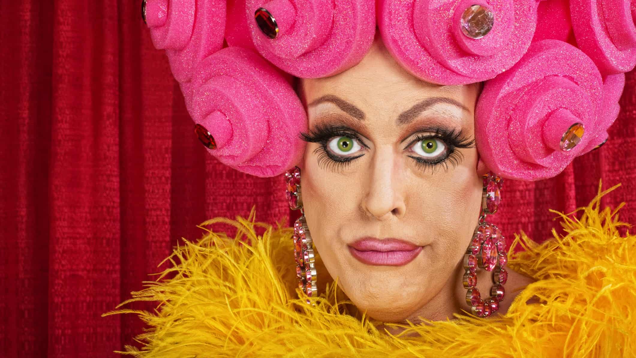 A drag queen beauty looks grim despite looking fabulous.
