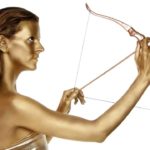 A golden woman shoots a bow and arrow high.