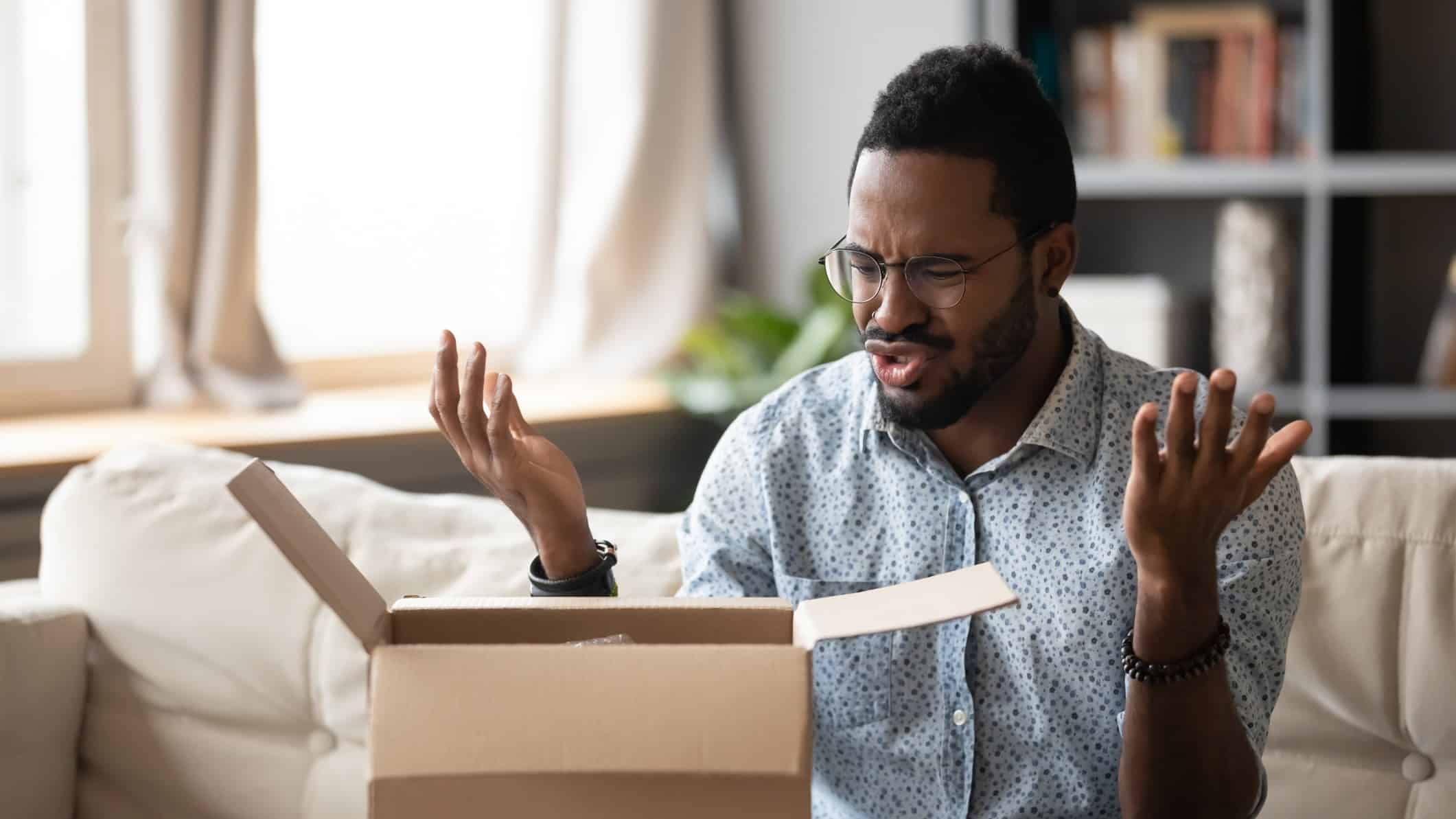 A man opens a box only to be disappointed at what's inside.