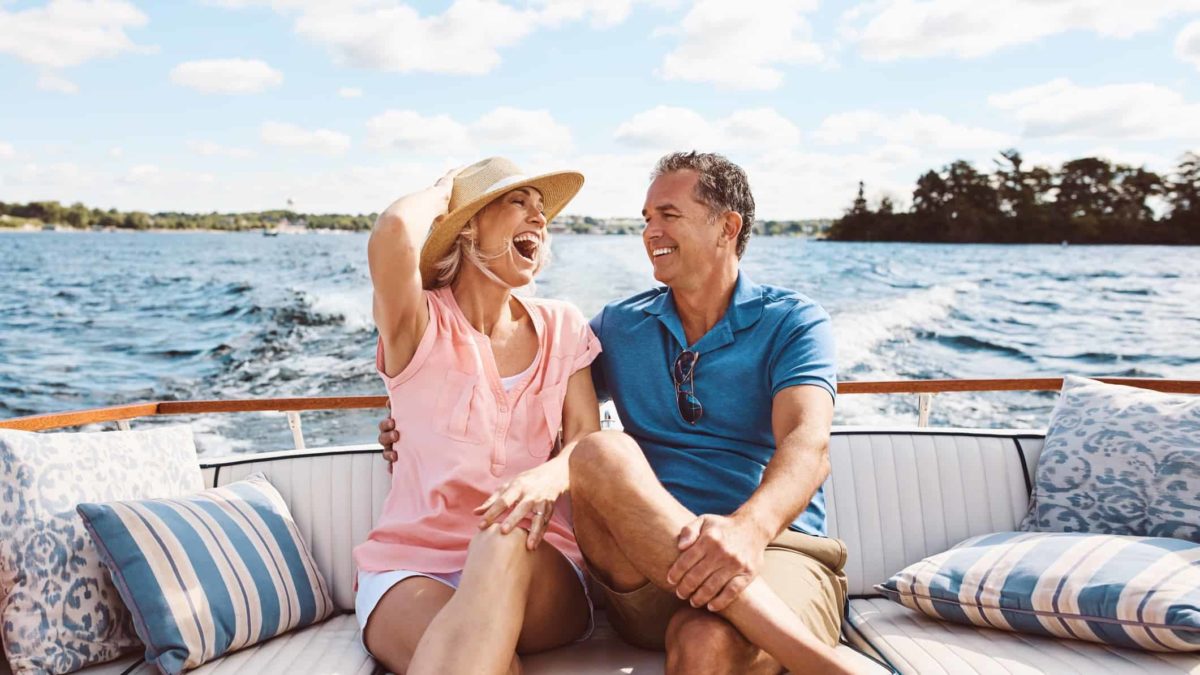 A couple are happy sitting on their yacht.