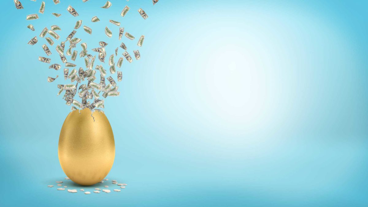 A golden egg with dividend cash flying out of it