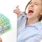 A happy woman holds a handful of cash dividends