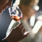 A woman sniffs a glass of win as part of a wine-tasting event