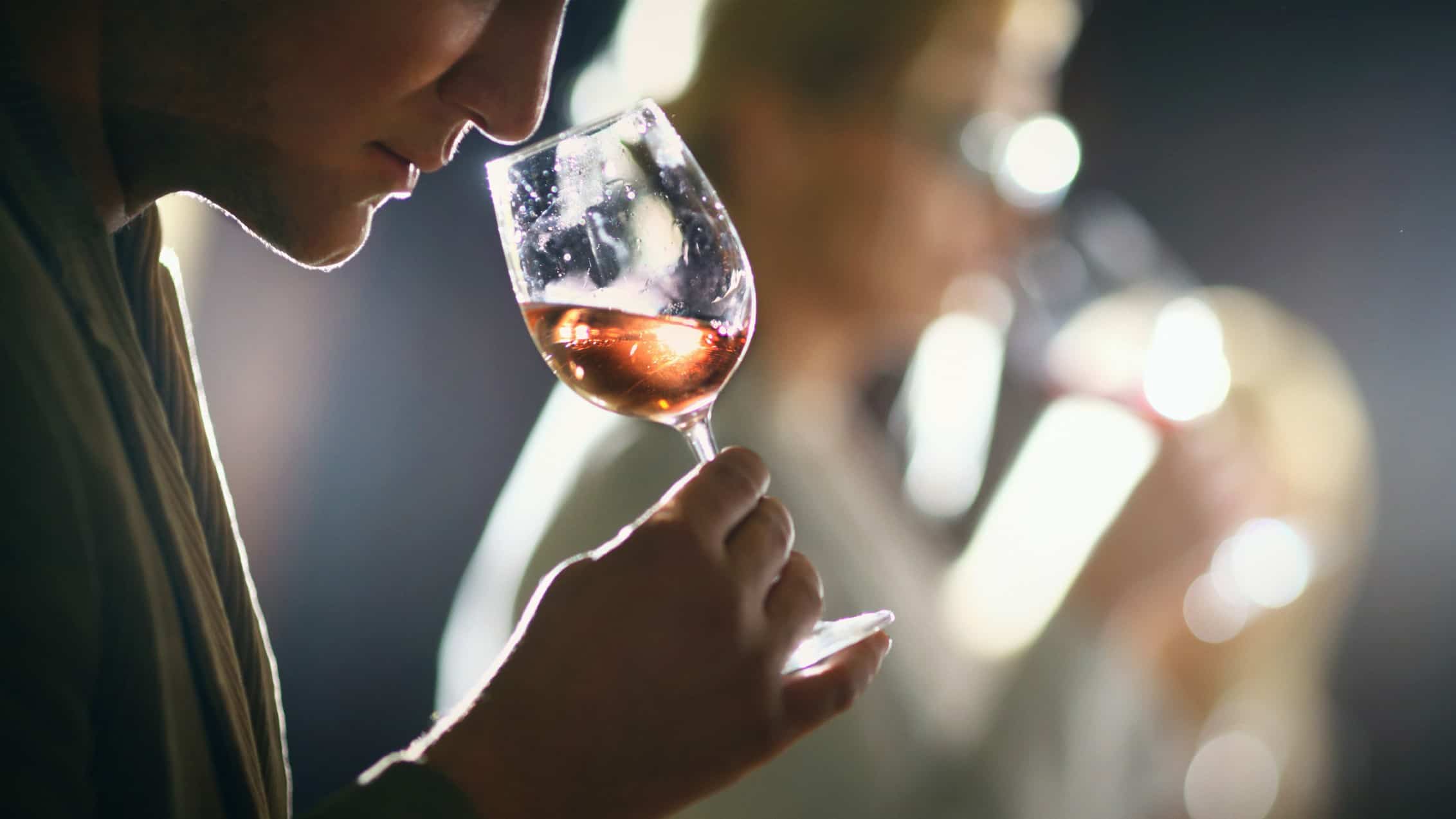 A woman sniffs a glass of win as part of a wine-tasting event