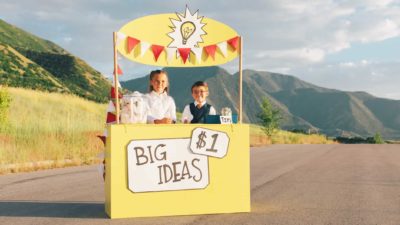 Two kids are selling big ideas from a lemonade stand on the side of the road for cheap!