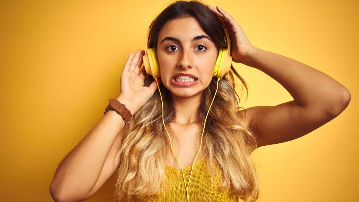 A girl wearing yellow headphones pulls a grimace, that was not a good result.