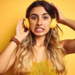 A girl wearing yellow headphones pulls a grimace, that was not a good result.