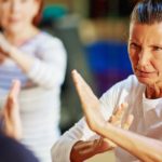 Two mature women learn karate for self defence.