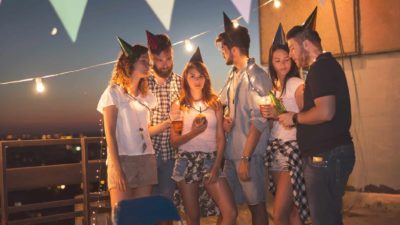 A group of young friends are supposed to be having a rooftop party but the lights have dimmed, the energy is low, and it's a bit of a downer.